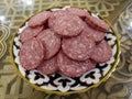 The sliced Ã¢â¬â¹Ã¢â¬â¹sausage on the porcelain plate